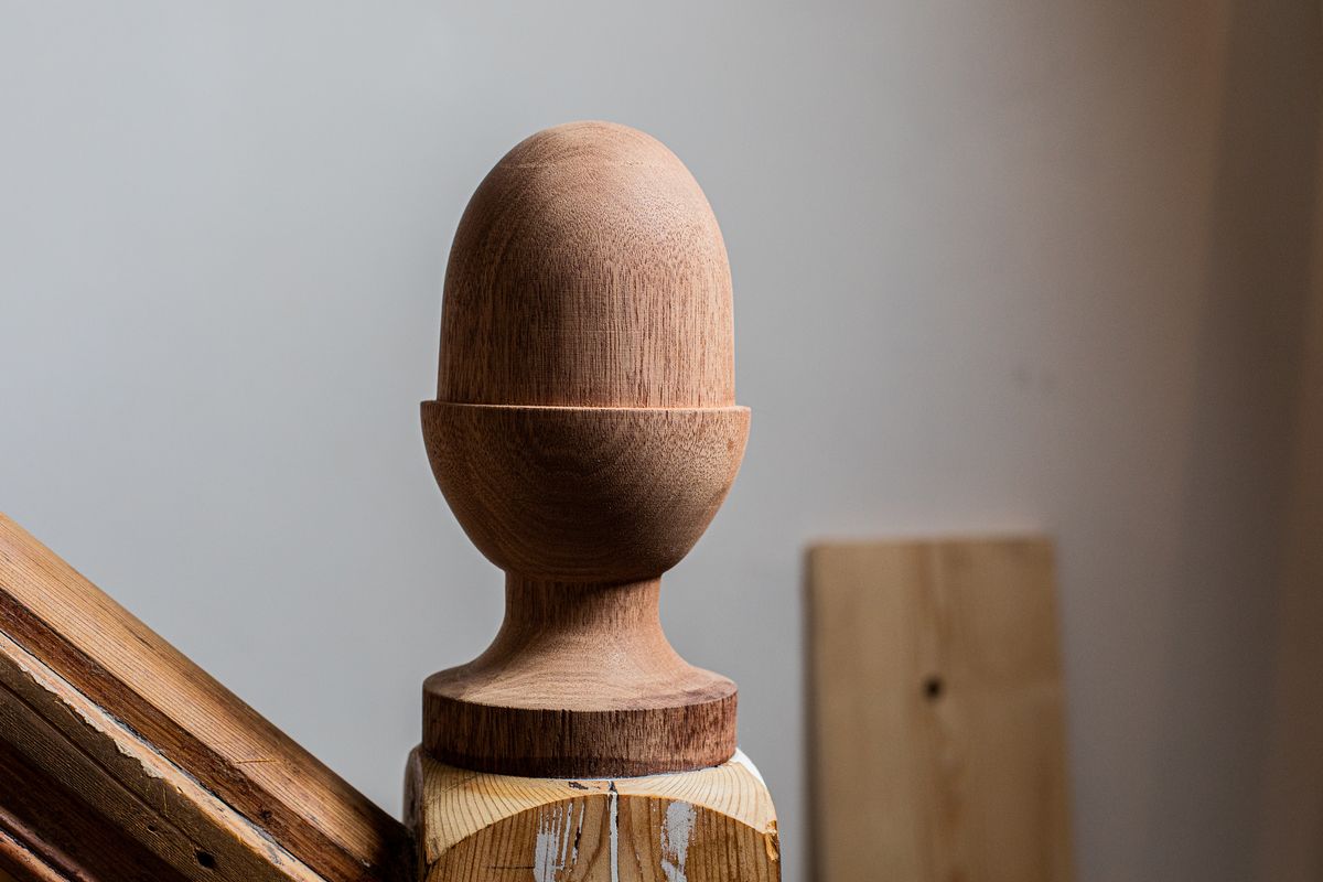 Closeup of a custom newel cap (staircase banister end), turned on our lathe, in the shape of an acorn