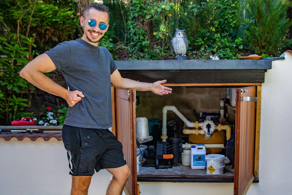 Sam gestures at an outdoor cupboard